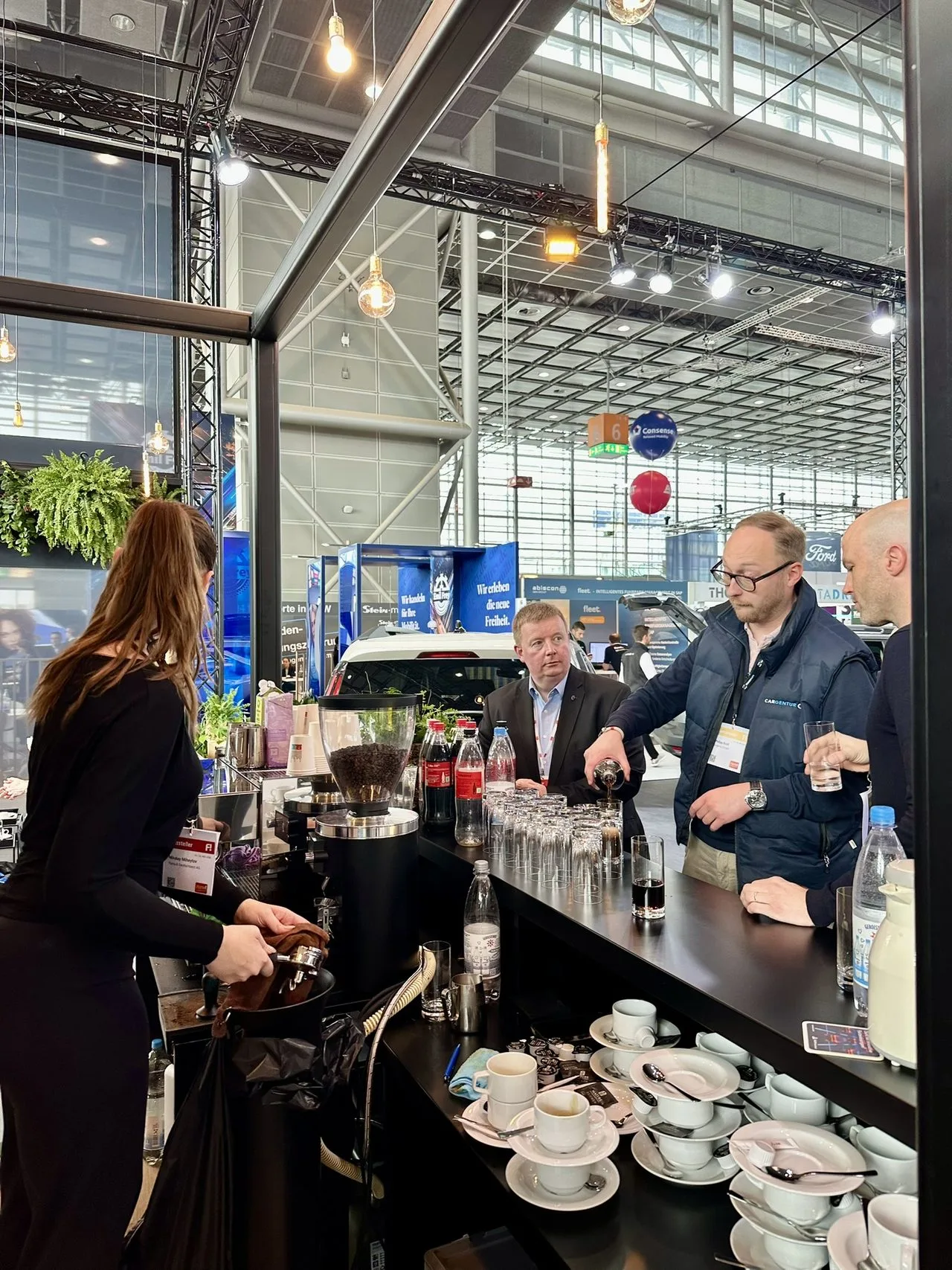 Logo latte art on a cappuccino served at a trade fair stand