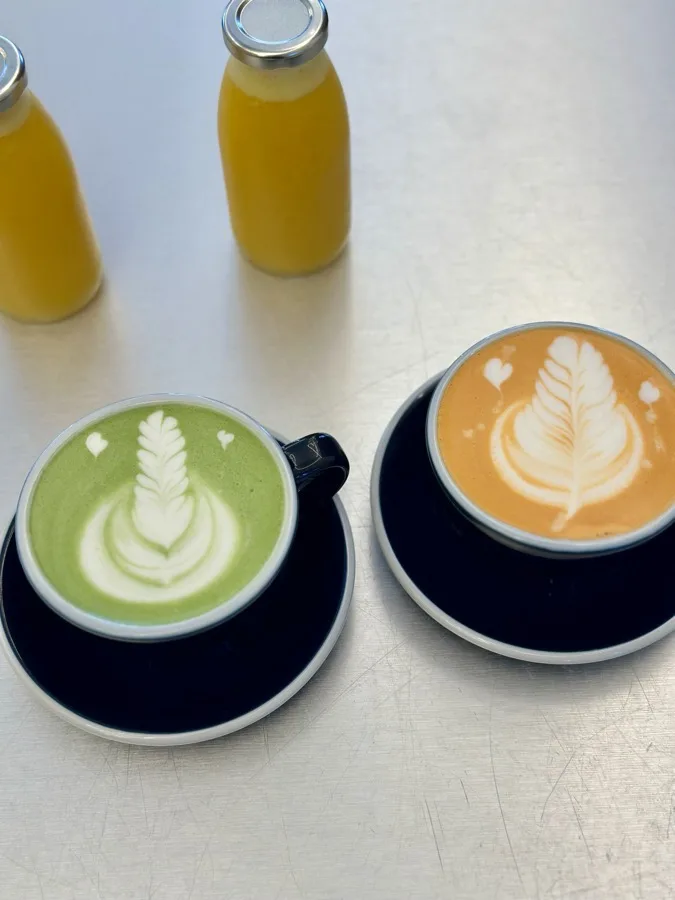 Matcha latte and fresh orange juice as healthy drink alternatives at an event