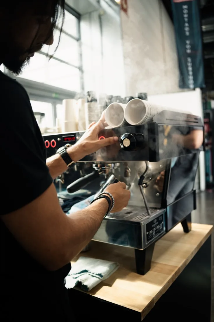 Barista pulling espresso at a trade fair coffee bar